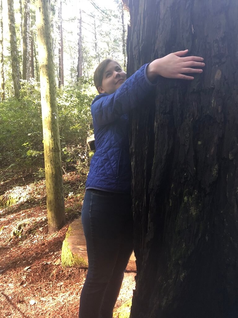 Livia hugging a redwood tree