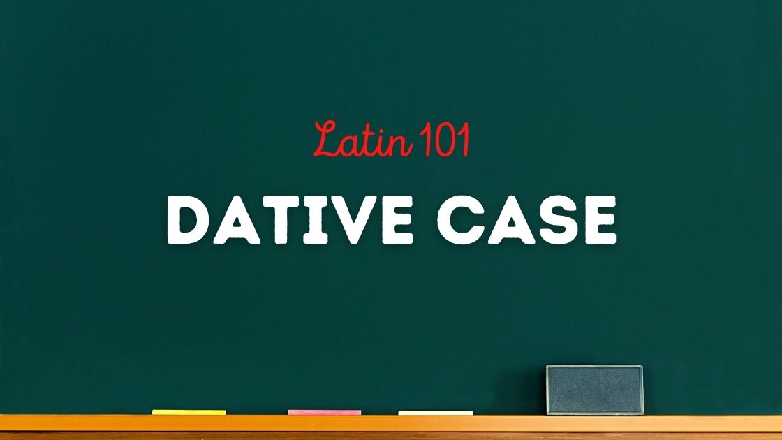Latin 101 dative case is written on a green chalkboard